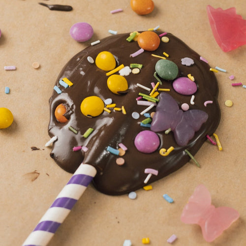 Photo of a chocolate lollypop decorated with sweets